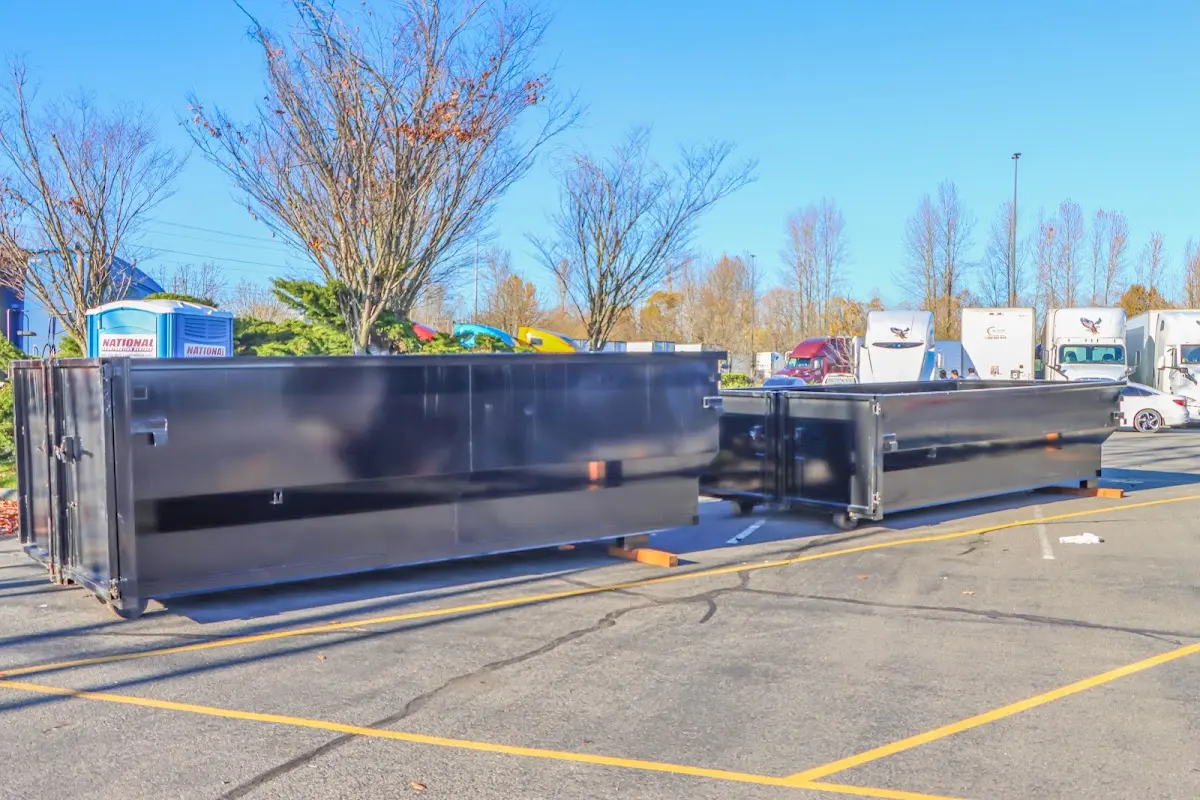 Professional dumpster rental service with roll-off container on residential driveway in Worcester